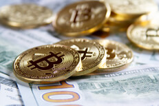 Bitcoins laying on top of new 100 dollar bills Bitcoins in rows and piles on top of new U.S. 100 dollar bills