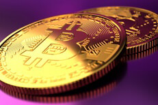 Two bitcoins on purple background Two Bitcoins with focus on front coin with hard light and fushia background