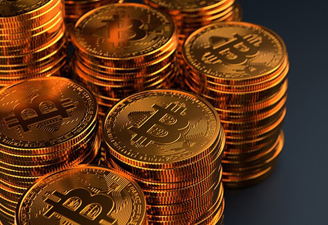 Many stacks of bitcoins Multiple stacks of Bitcoins on dark background with stacks exiting left side of frame