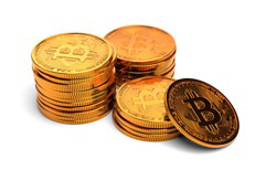 Stacks of bitcoins isolated on white Three small stacks of Bitcoins with one coin leaning against a small stack