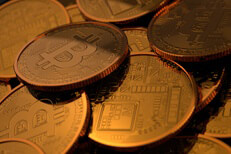 Random pile of Bitcoins with low key lighting