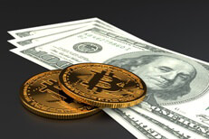 Two bitcoins on US currency Two Bitcoins laid on three one hundred dollar bills