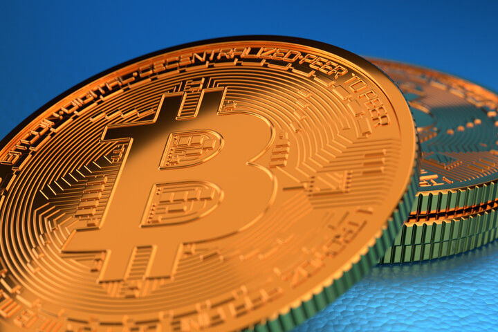 Bitcoins with hard spot light on blue background