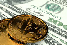 Two bitcoins on US currency Two Bitcoins laying on U.S. currency