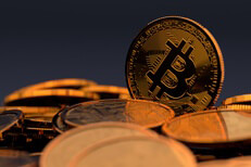 Bitcoin stands out Random pile of Bicoins with one Bitcoin standing vertically
