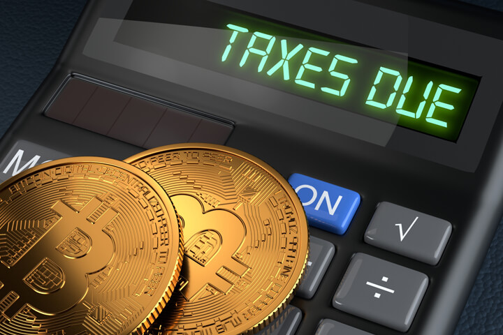 Two Bitcoins on calculator with LCD reading Taxes Due to illustrate tax implications of owning Bitcoin or other cryptocurrency