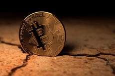 Bitcoin in mud crack Bitcoin on edge in dry, cracked desert
