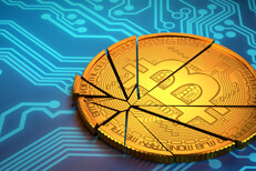 Broken Bitcoin on circuit board Broken Bitcoin lying on blue circuit board representing price decline of cryptocurrencies