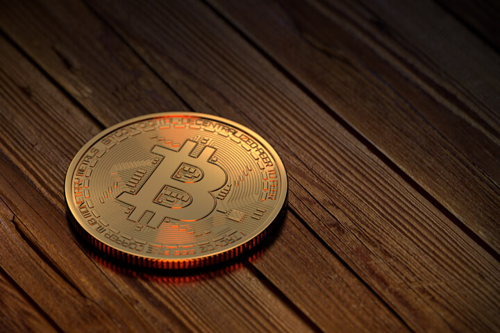 Bitcoin on wood boards with orange lighting on edges