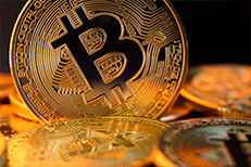Bitcoin on edge Close view of a bitcoin on edge in a pile of bitcoins