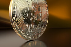 Scratched Bitcoin with satin background Scratched Bitcoin on edge with orange satin background and reflection