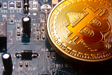 Bitcoin on a graphics card Bitcoin at angle on a graphics card showing circuits and capacitors