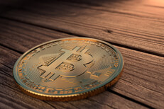 Bitcoin on weathered wood corner light Single Bitcoin placed on weathered wood boards with upper right corner light