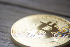Bitcoin angle view on wood planks Bitcoin with soft back light on weathered wood planks