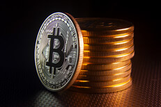 Bitcoin leaning against coin stack Free photo of a Bitcoin leaning against a stack of Bitcoins dark background