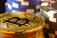 Stack of Bitcoins with poker chips Stack of bitcoins with stacks of blue and black poker chips