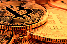 Bitcoin pile side view Random pile of Bitcoins with camera positioned low front with hard back lighting