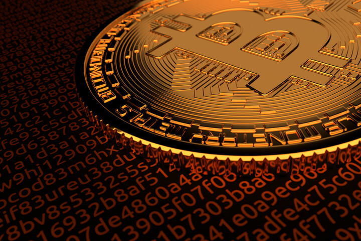 Bitcoin laid on red illuminated code representing digital currency, blockchain, or cryptocurrency