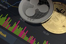 Bitcoin and XRP coins on mobile app Bitcoin and Ripple XRP coins on mobile phone screen showing stock market trading app