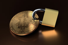 Bitcoin secured with padlock Bitcoin secured with padlock on reflective metallic surface