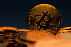 Bitcoin on edge in pile Bitcoin standing on edge in pile of random Bitcoins