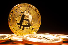 Bitcoin standing on edge Bitcoin on edge with other scattered bitcoins