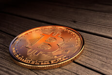 Bitcoin with sunset reflection Bitcoin placed on weathered wood planks with reflection of desert sunset