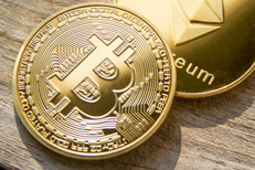 Bitcoin and Ethereum coins Bitcoin with Ethereum coin on wood background