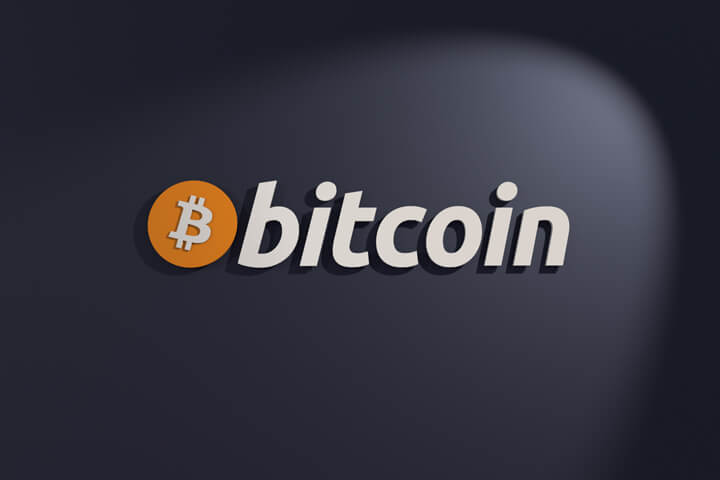 Bitcoin icon logo on dark wall with spotlight front view