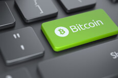 Computer keyboard with green Bitcoin key