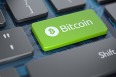 Computer keyboard with green Bitcoin key and circuit board background