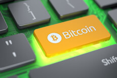 Glowing bitcoin keyboard key Laptop keyboard with orange Bitcoin key and circuit board glowing with bright light from below