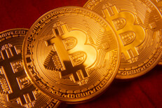 Bitcoins stacked in order Bitcoins in orderly stack on rich cherry wood desk