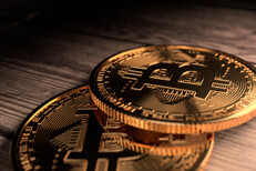 Close up of two Bitcoins Close up photo of two Bitcoins placed on rough weathered wood plank background