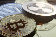 Close up of pile of cryptocurrency coins Close up photo of a pile of crypto coins including Bitcoin, Ripple, Litecoin, and Ethereum