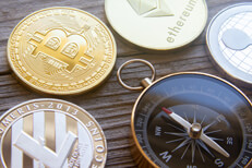 Compass pointing at Bitcoin Litecoin, Bitcoin, Ethereum, and Ripple coins with navigation compass pointing at Bitcoin
