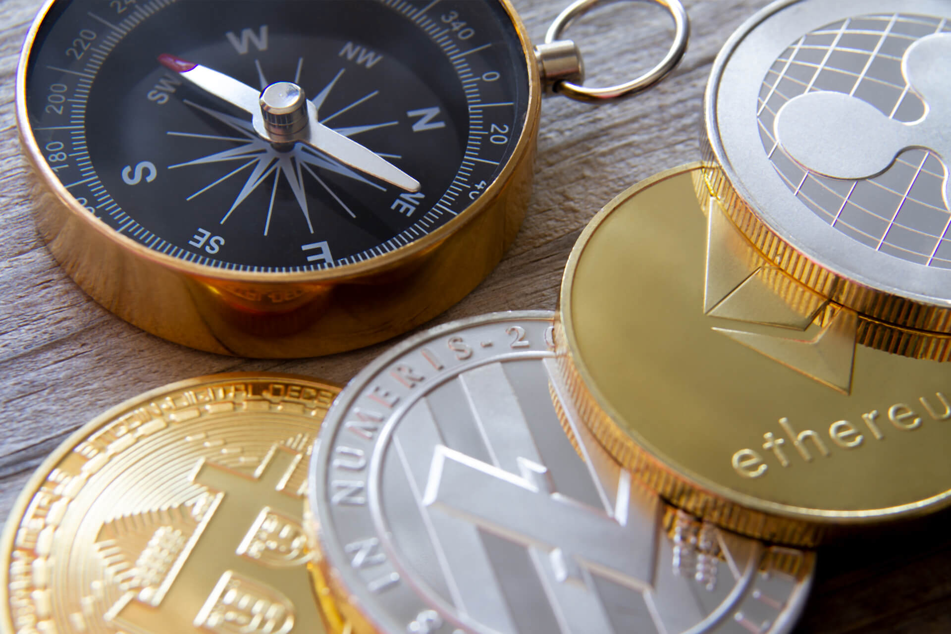 Row of crypto coins with compass free image download