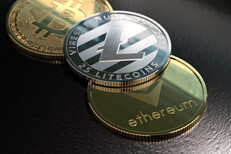 Crypto coins next to window Ethereum, Litecoin, and Bitcoin on rough surface with window light