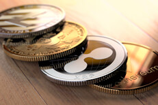Row of crypto coins on wood Curved row of cryptocurrency coins on wood floor