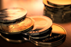 Crypto coins in morning light Bitcoin, Ripple, Litecoin, and Ethereum coins in morning light