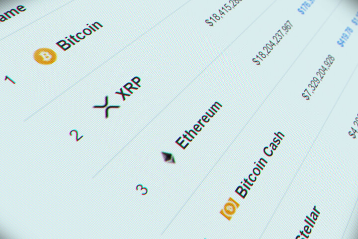 Computer monitor screenshot of cryptocurrencies showing Bitcoin, XRP, Ethereum, Bitcoin Cash, and Stellar logos with market cap values