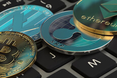 Crypto coins on keyboard Bitcoin, Litecoin, Ripple XRP, and Ethereum coin on Apple MacBook Pro keyboard