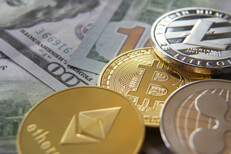 Cryptocurrency coins with 100 dollar bills Bitcoin, Ethereum, Litecoin, and Ripple coin on scattered 100 dollar bills