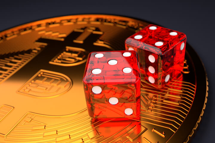 Large shiny Bitcoin with two dice on face representing investment risk in Bitcoin and altcoin