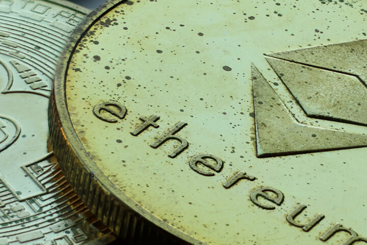 Bitcoin and Ethereum cryptocurrency coins with tarnish and wear extreme closeup photo
