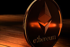 Ethereum coin on edge Ethereum coin on edge on wood surface with orange highlight reflection