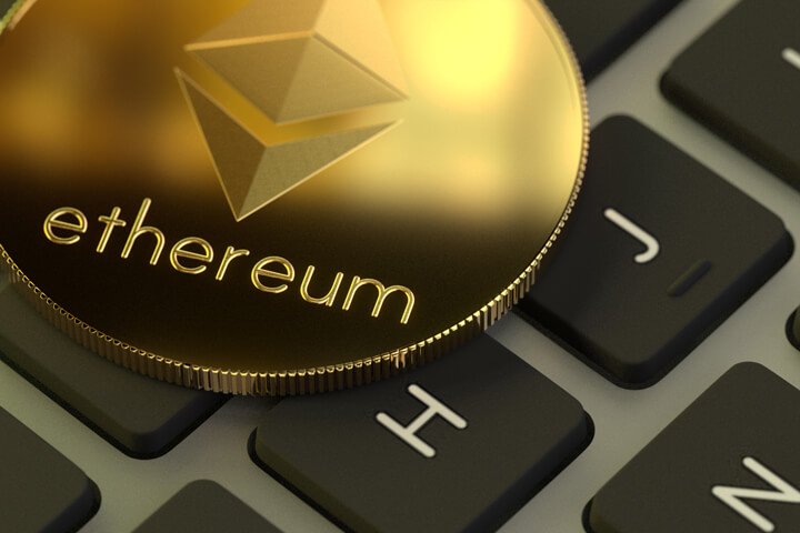 Ethereum coin with soft window reflection on laptop keyboard