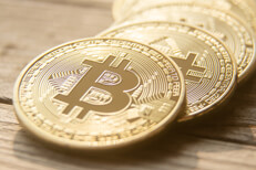 Curved fallen stack of bitcoins Curved row of Bitcoins on a blurred wooden background