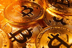 Pile of scattered bitcoins with gold lighting