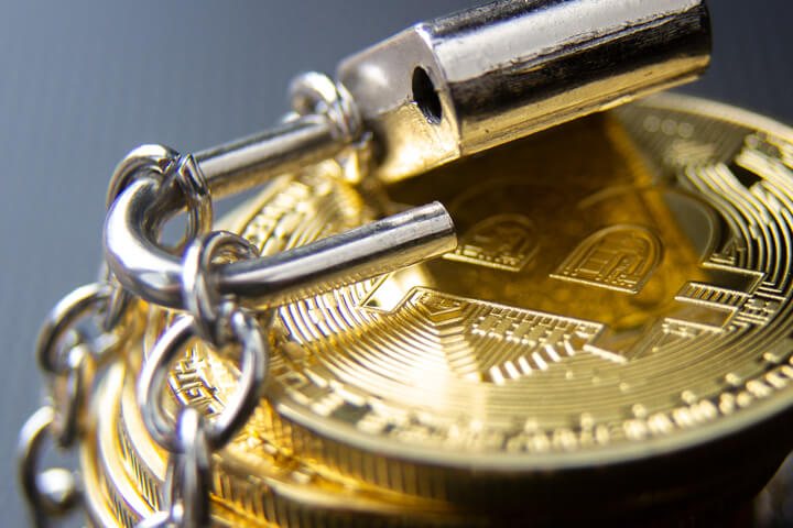 Stack of bitcoins wrapped in chains with unlocked padlock concept for insecure cryptocurrency